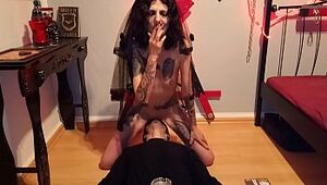 Slurping blasphemic whore, while she smokes and rails a crucifix fake penis